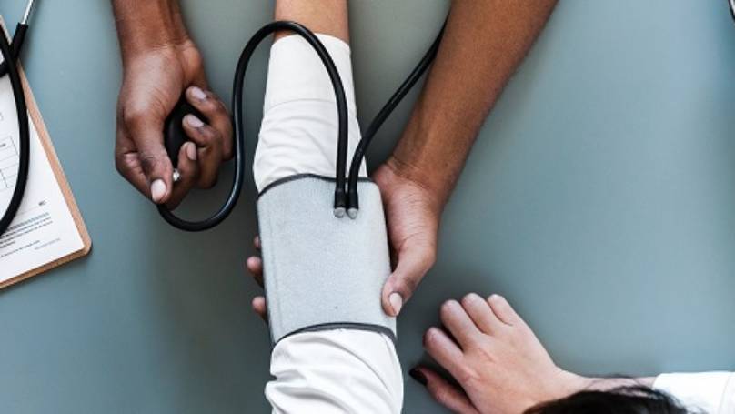 Doctor taking blood pressure of a patient