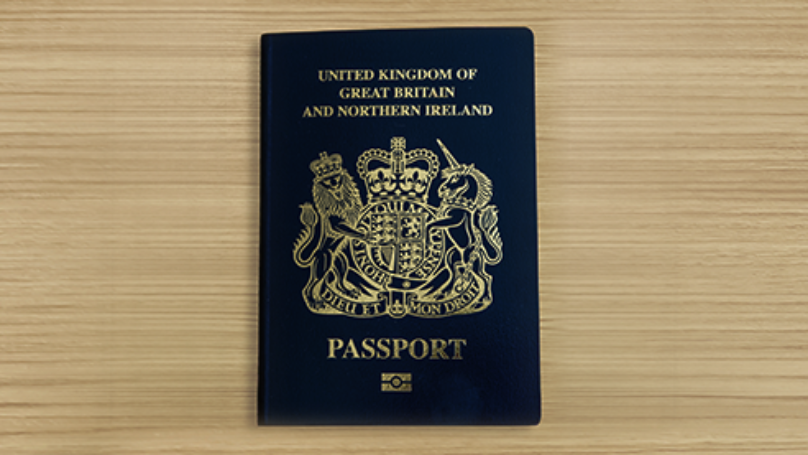 United Kingdom of Great Britain and Northern Ireland biometric passport on wooden surface