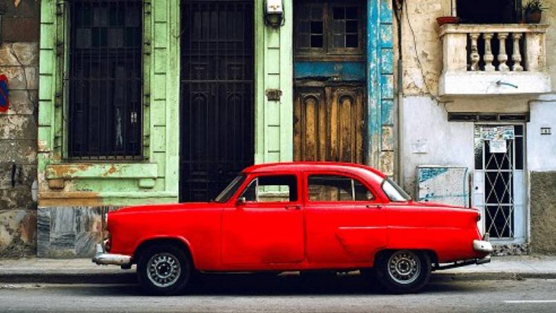 Classic red car parked in Havana street, Cuba