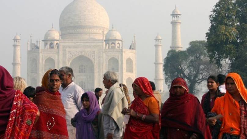Taj Mahal in distance with people in the foreground