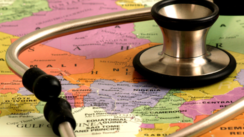Doctor stethoscope resting on top of a world map