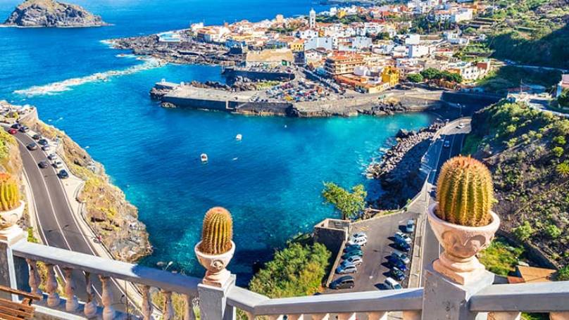 Elevated view of small coastal town in Canary Islands surrounded by blue waters