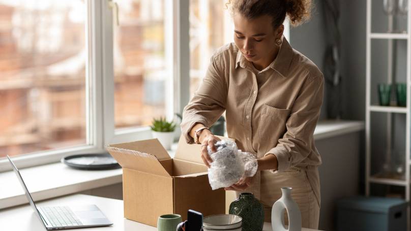 lady packing an item into delivery box