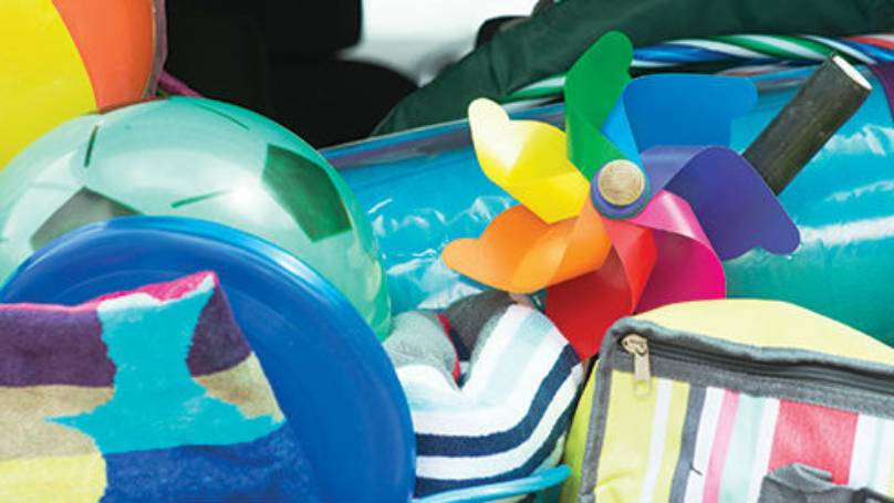 Beach balls, spades, a mat and cooler bag bundled together
