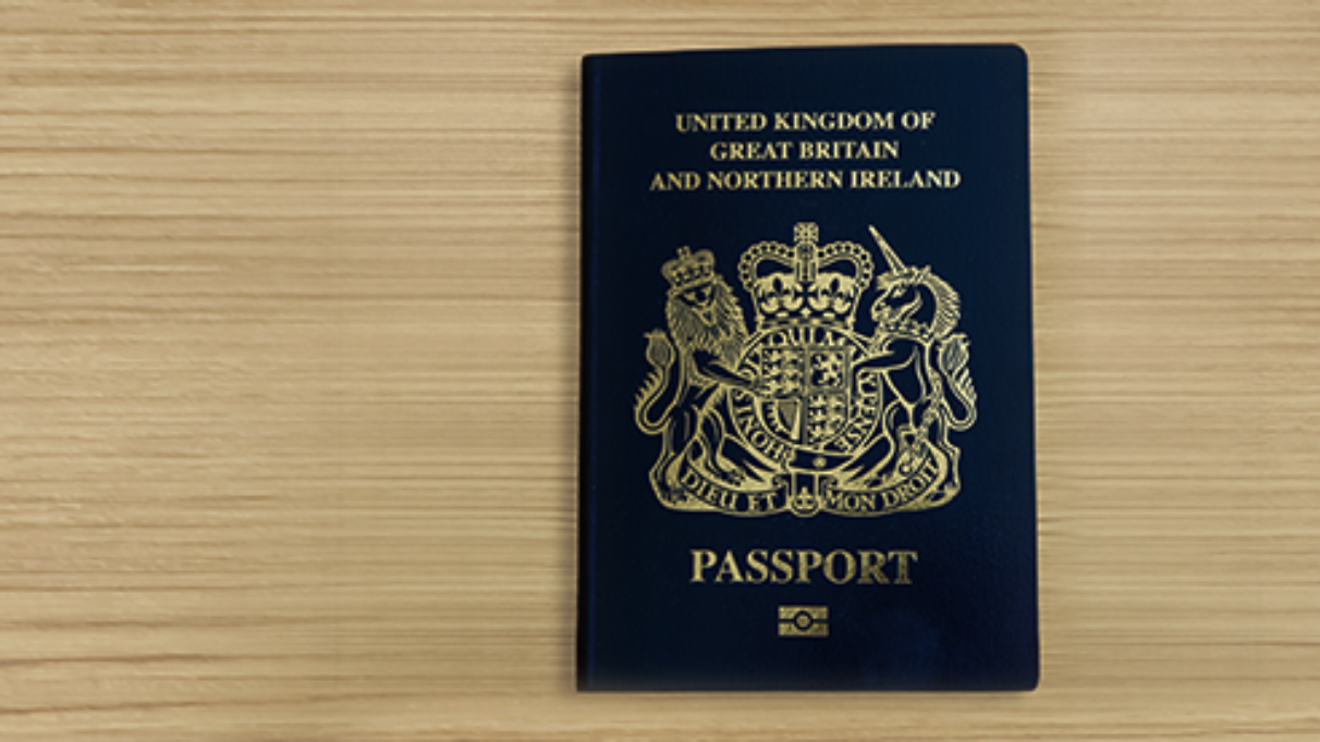 United Kingdom of Great Britain and Northern Ireland biometric passport on wooden surface