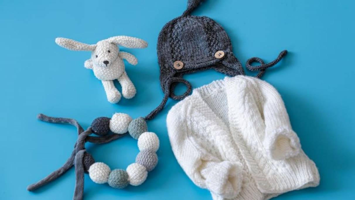 blue and white baby clothes and toys