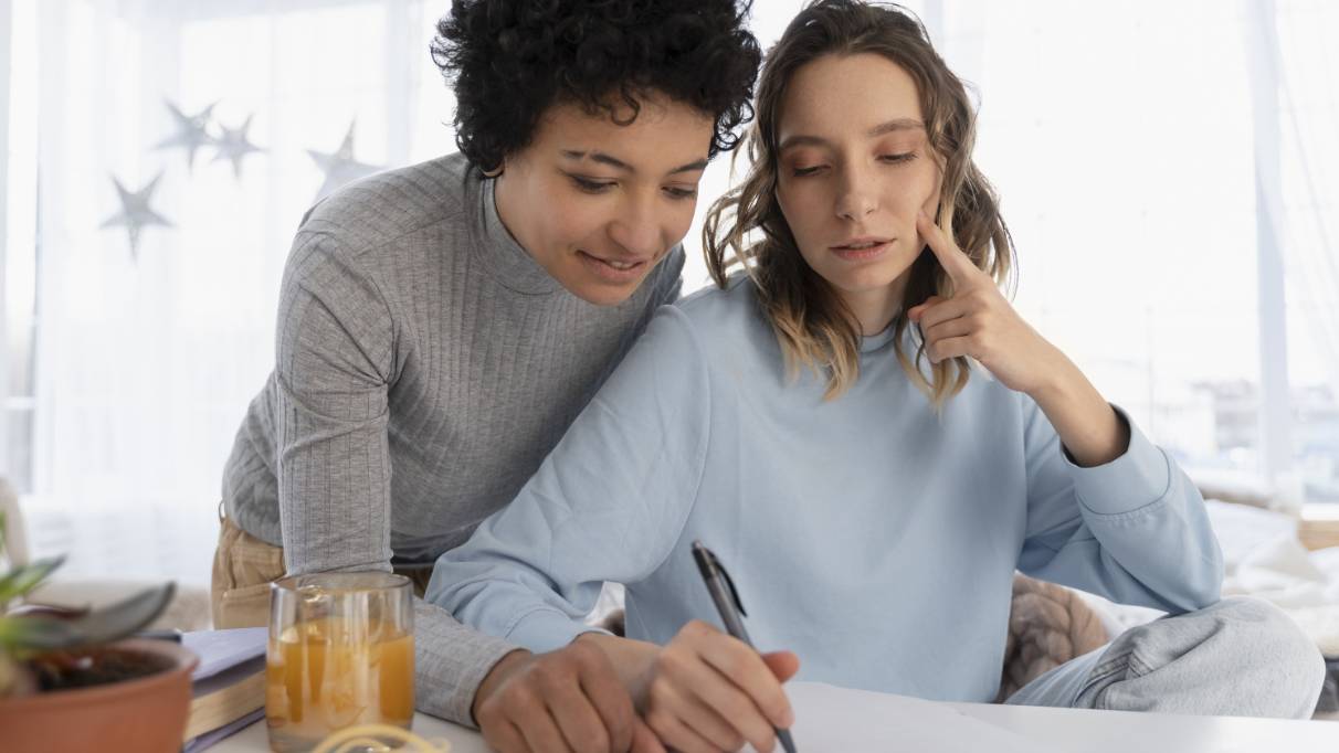 A couple reviewing and writing on a paper document