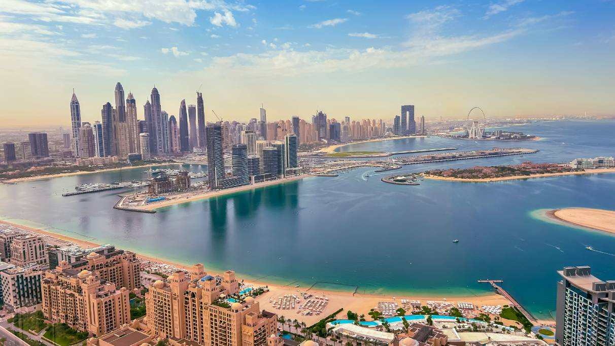 Aerial view of Dubai with Burj Khalifa, skyscrapers, and a turquoise lake