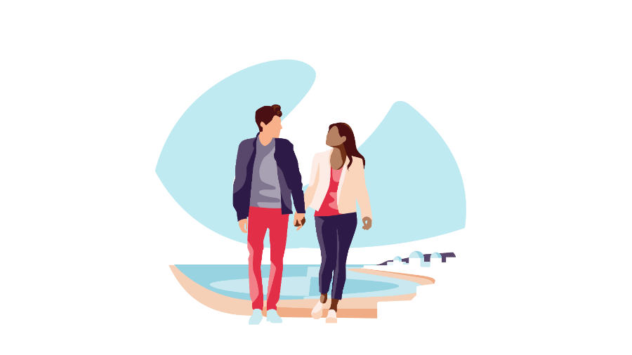 a young couple walking hand in hand by a lake