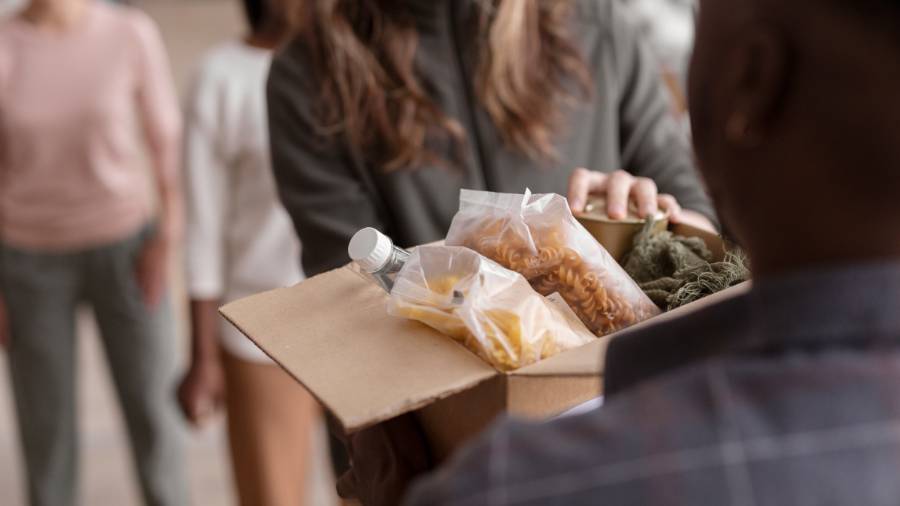 a person receiving a box of food products