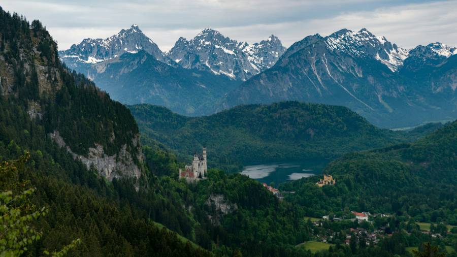 Bavarian alps with castle and forest