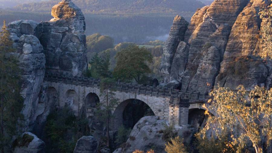 Old bridge in mountainous area of Saxony at sunset
