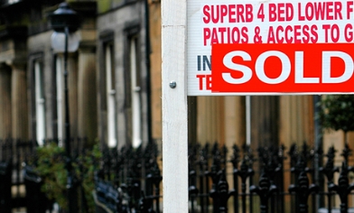 Sold Board in front of a house