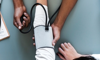 Doctor taking blood pressure of a patient