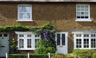 semi detached house with green plat above the window and door