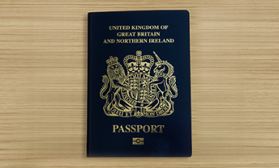 United Kingdom of Great Britain and Northern Ireland biometric passport on wooden surface
