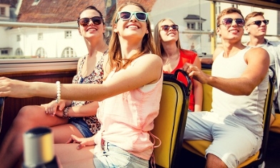 A group of friends on the top deck of a tourist bus
