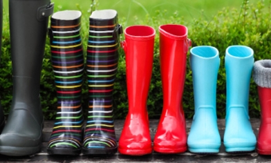 5 pairs of different coloured wellington  boots lined up next to each other 