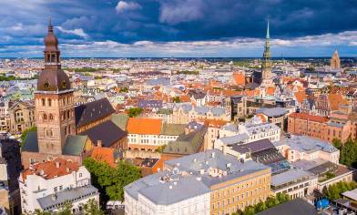 An aerial view of the colourful rooves and spires of the city of Riga in Latvia under dramatic clouds