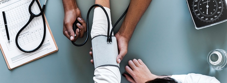 Doctor taking blood pressure of a patient