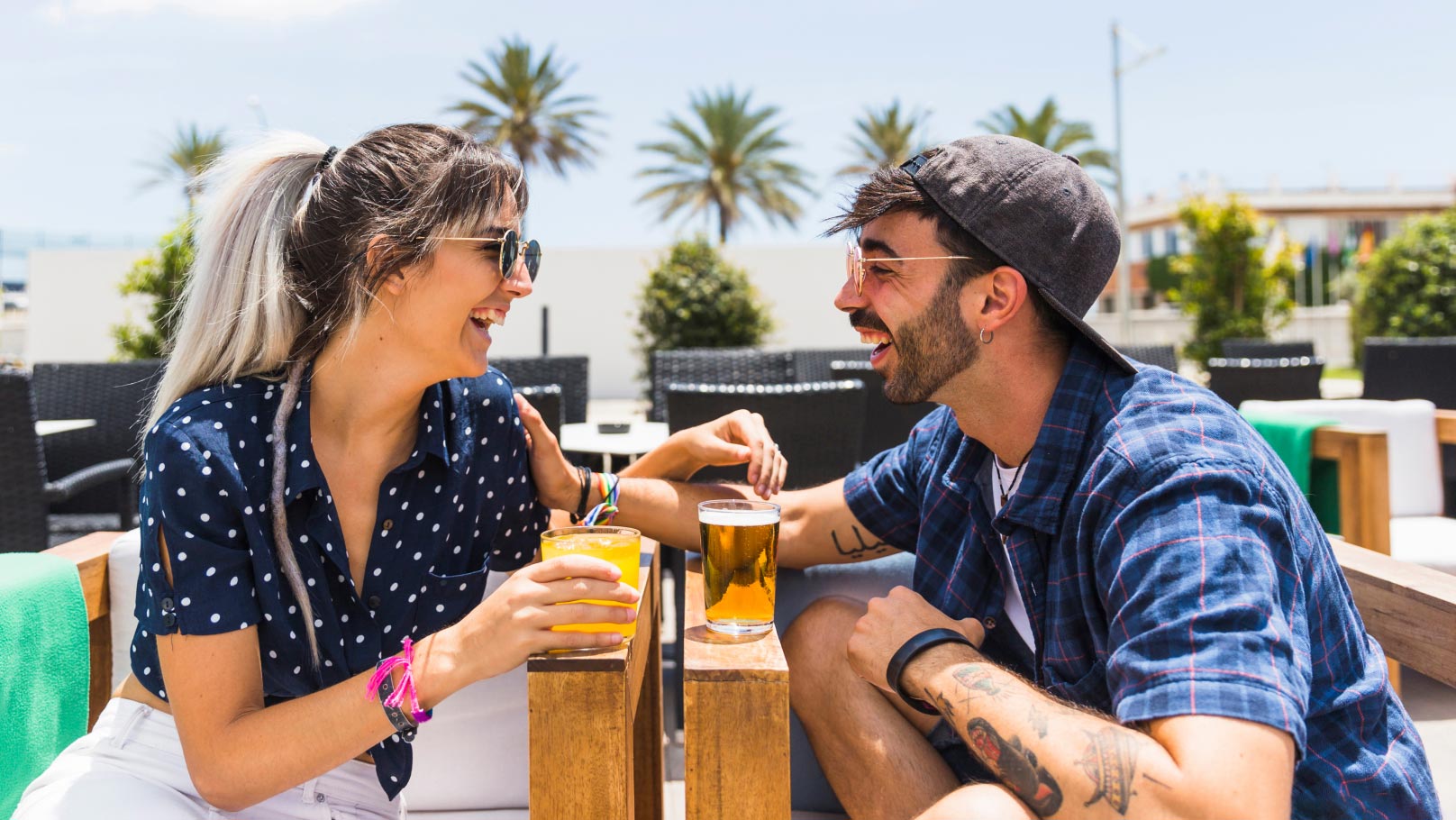 a happy couple having drinks at a beachside lounge