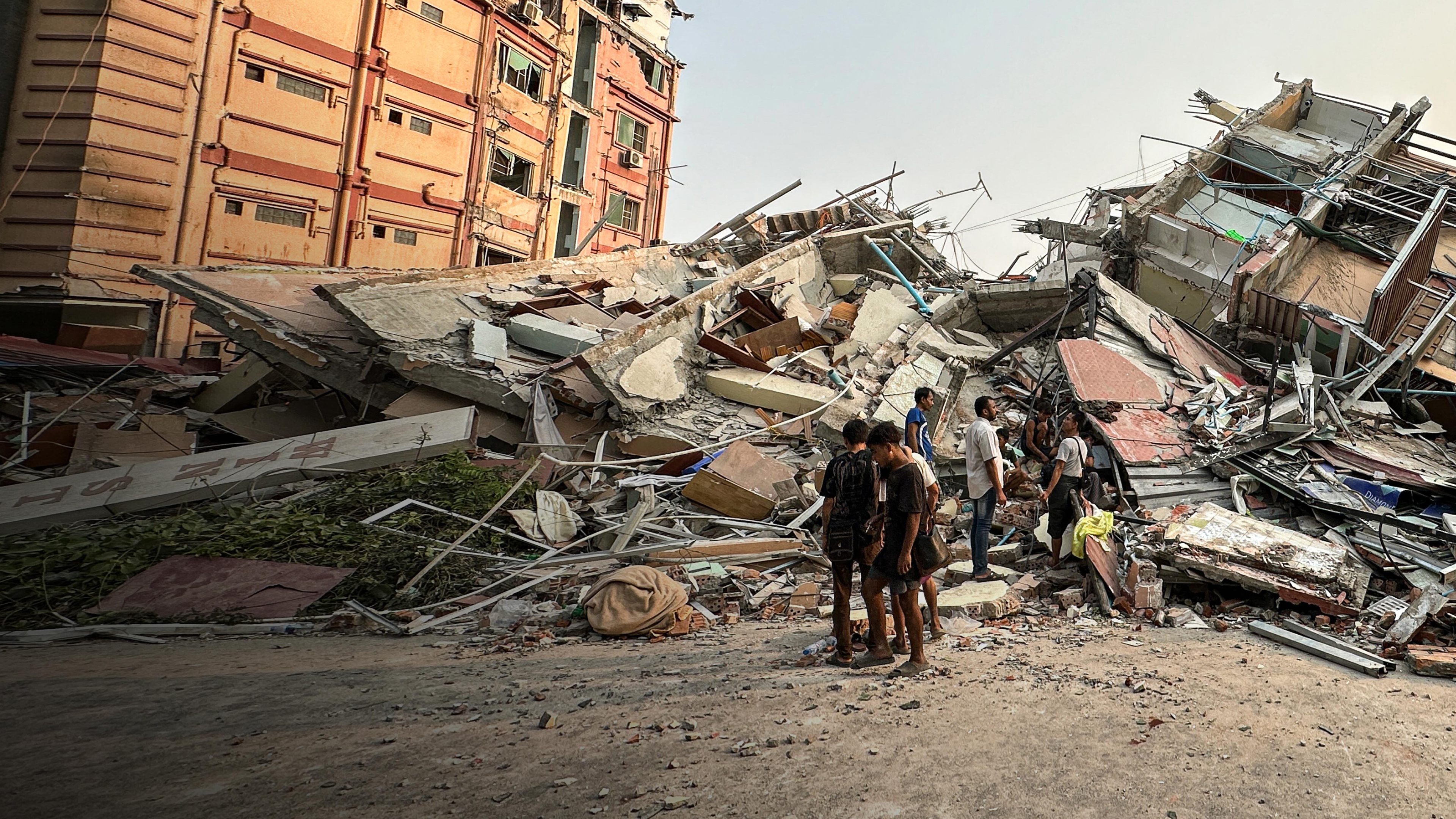 people in front of rubble
