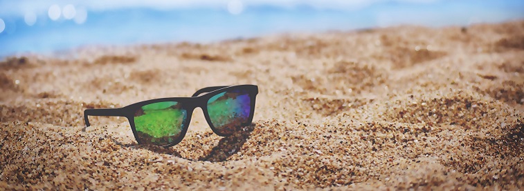 Sunglasses sitting in sand on a beach