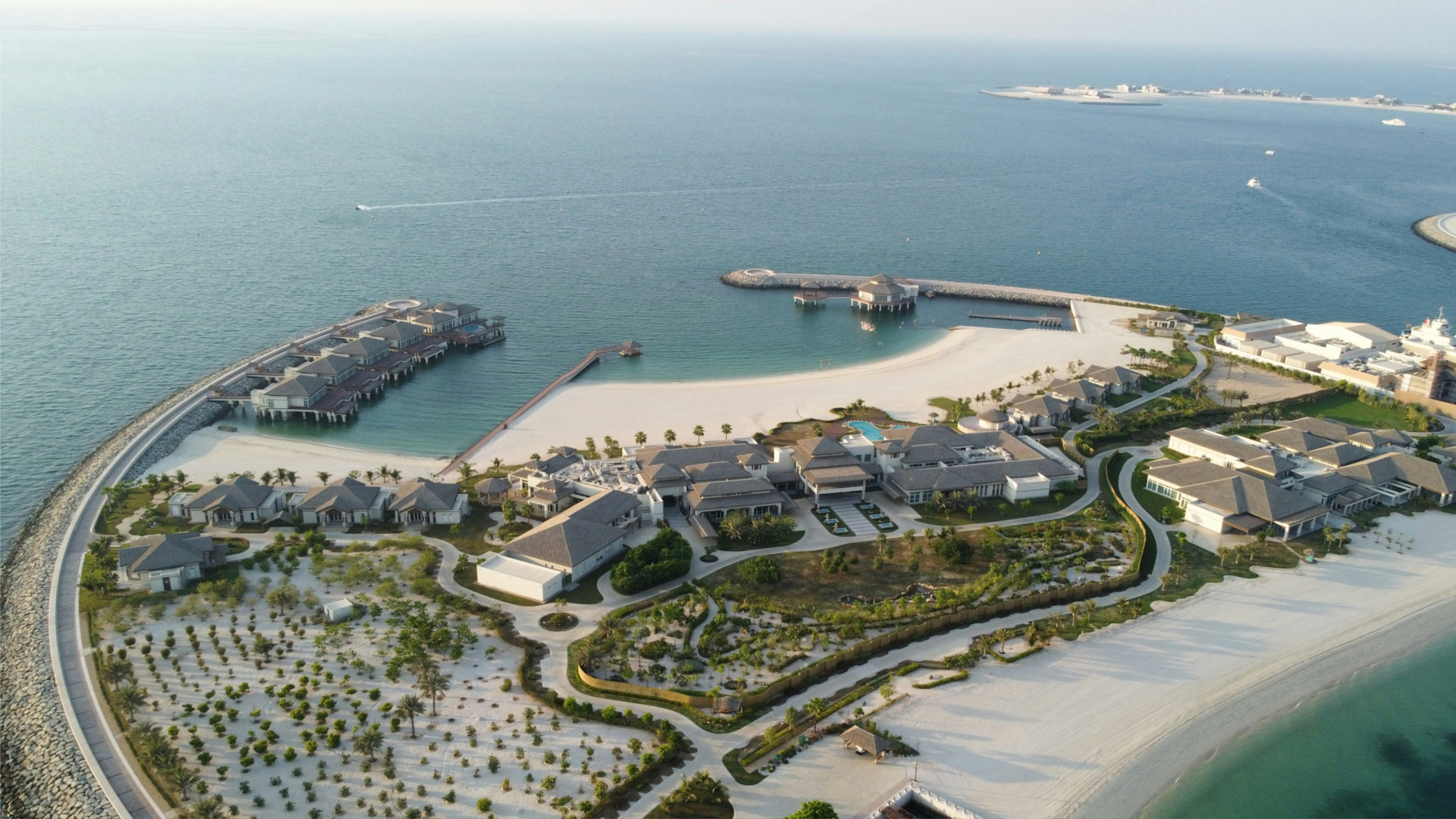 Aerial view of Jumeirah Beach with resorts, sandy shore, and yachts in clear blue water