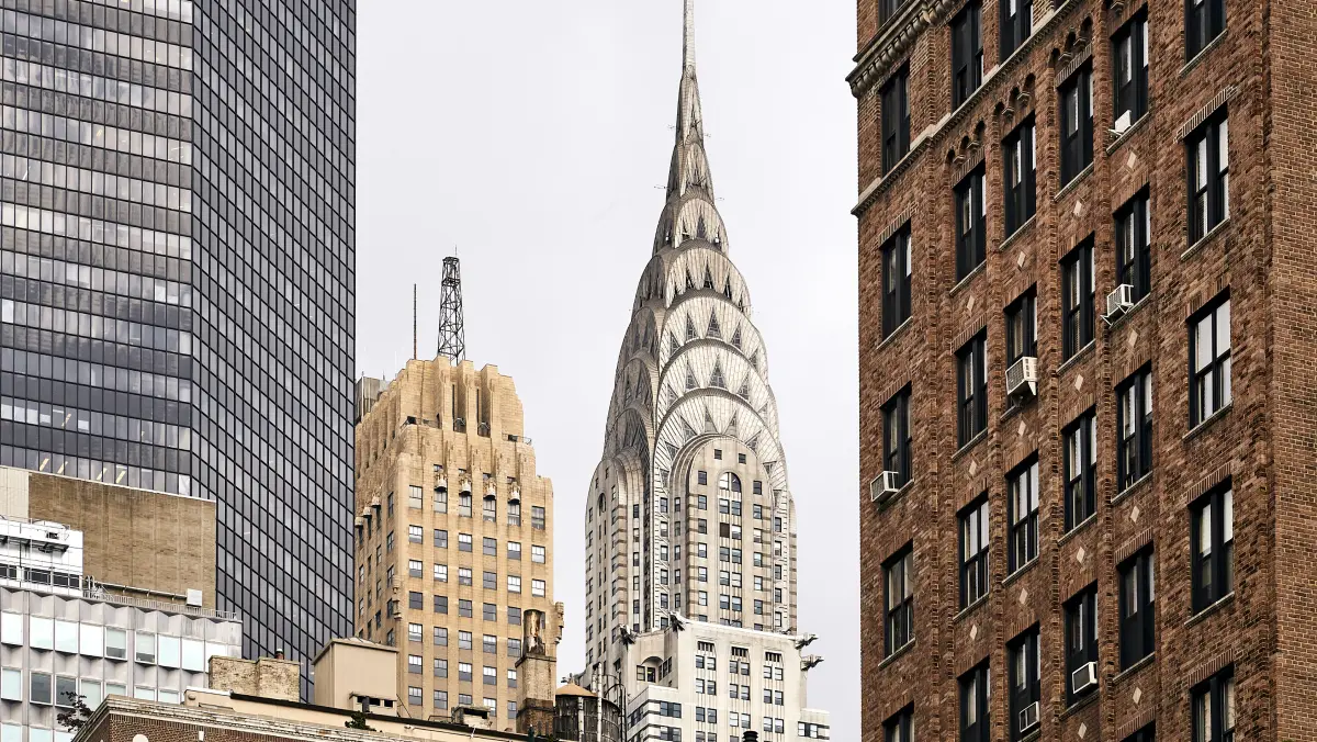 New York City skyline view from the pavement featuring the art deco spire of the Chrysler building