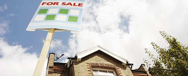 For sale Board in front of a house