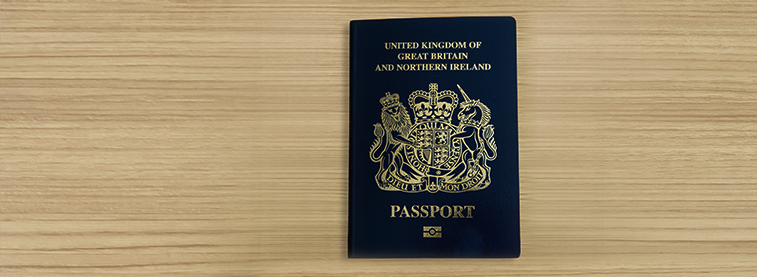 United Kingdom of Great Britain and Northern Ireland biometric passport on wooden surface