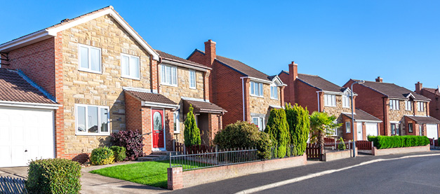 Row of houses on left side of a long road