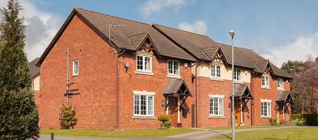 Row of houses on left side of a short road