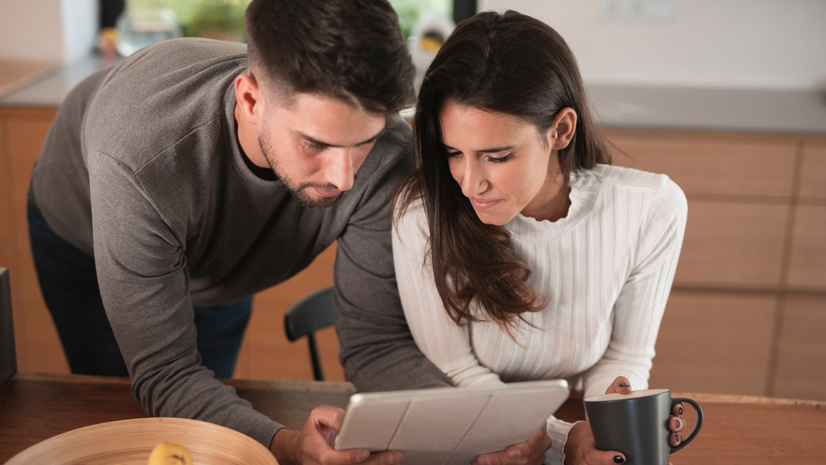 A couple reviewing their finances on an ipad