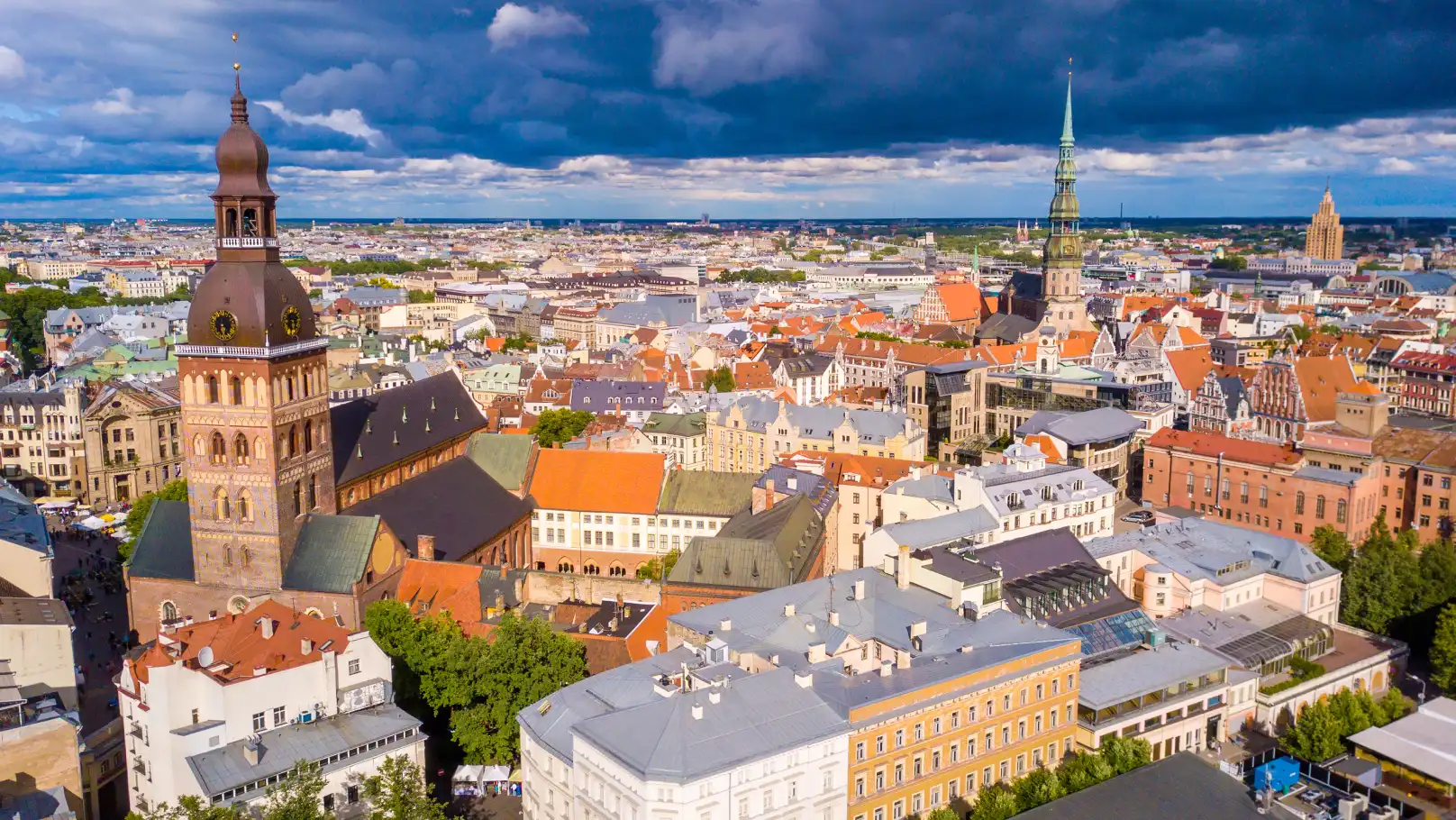 An aerial view of the colourful rooves and spires of the city of Riga in Latvia under dramatic clouds