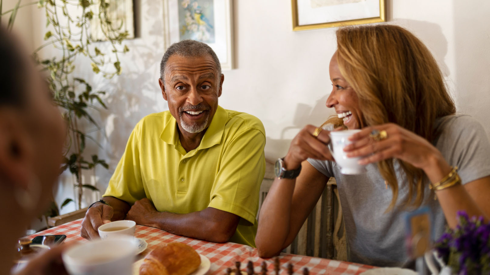 a group of over 60s smiling and drinking a hot beverage