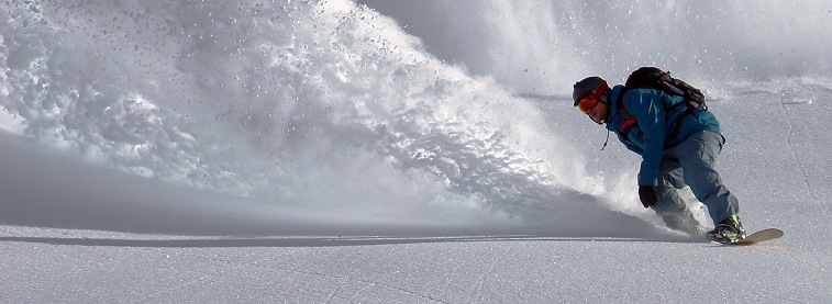 Snowboarder and snow spray