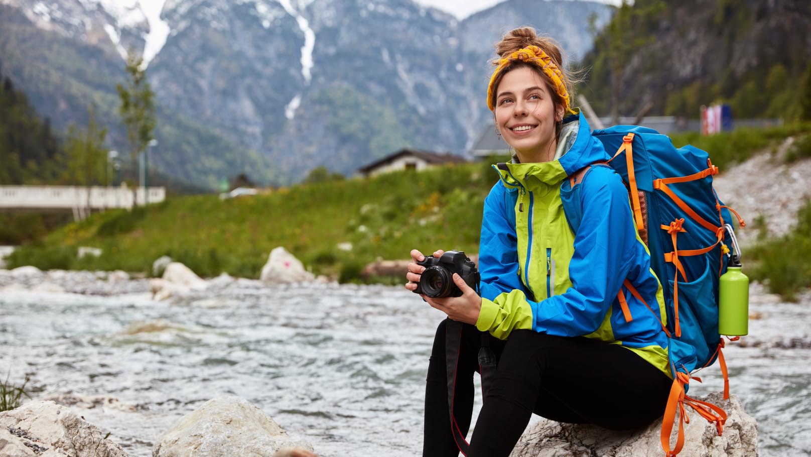 a person sitting on a rock in the mountains