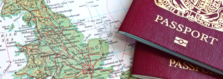 Two biometric passports on top of a map of Great Britain