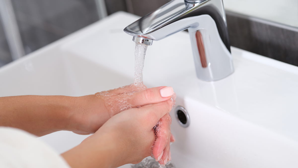 Hand washing under running water from a tap
