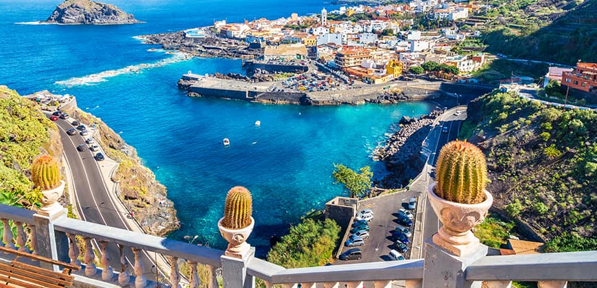 Elevated view of small coastal town in Canary Islands surrounded by blue waters
