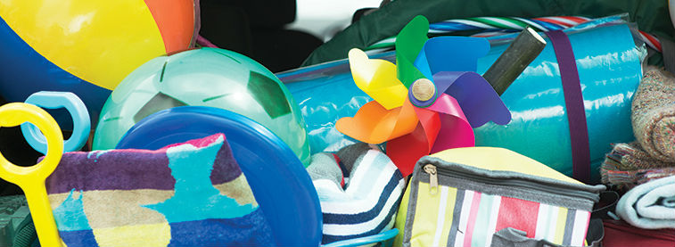 Beach balls, spades, a mat and cooler bag bundled together