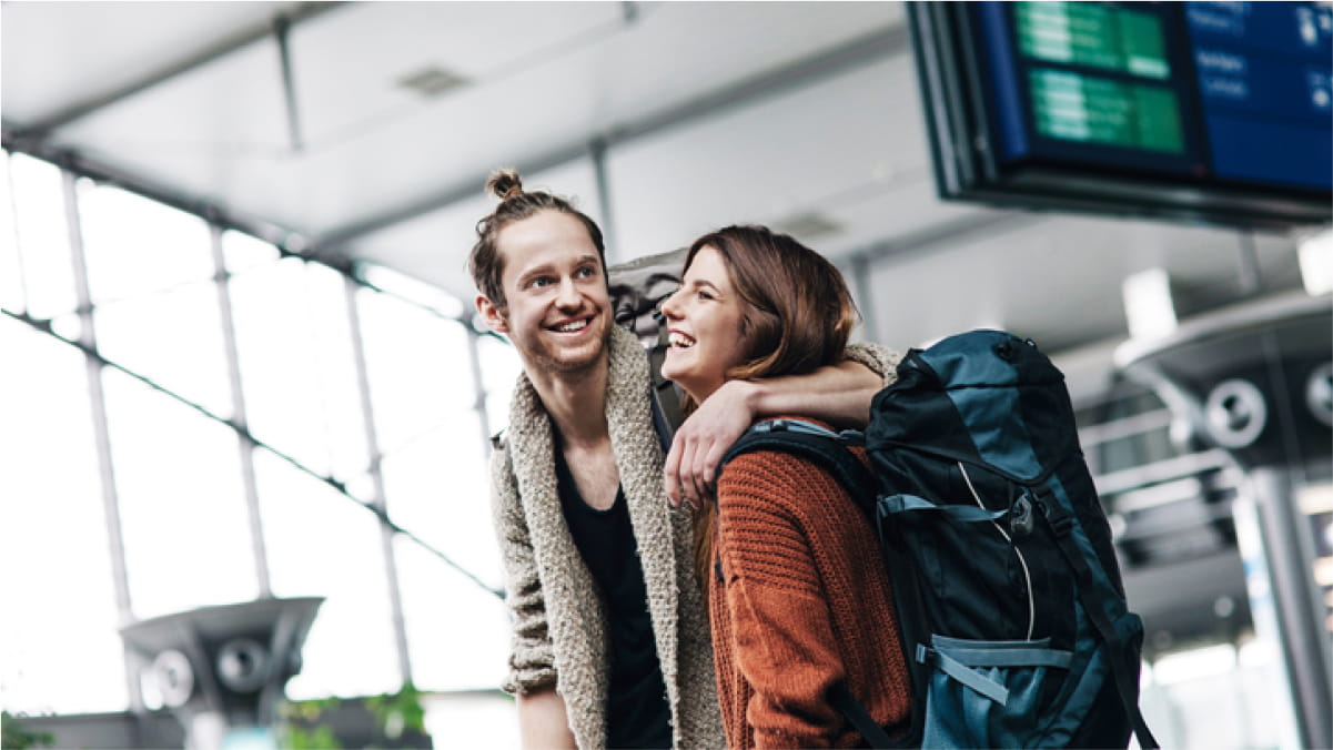 Male has his arm around female carrying a backpack