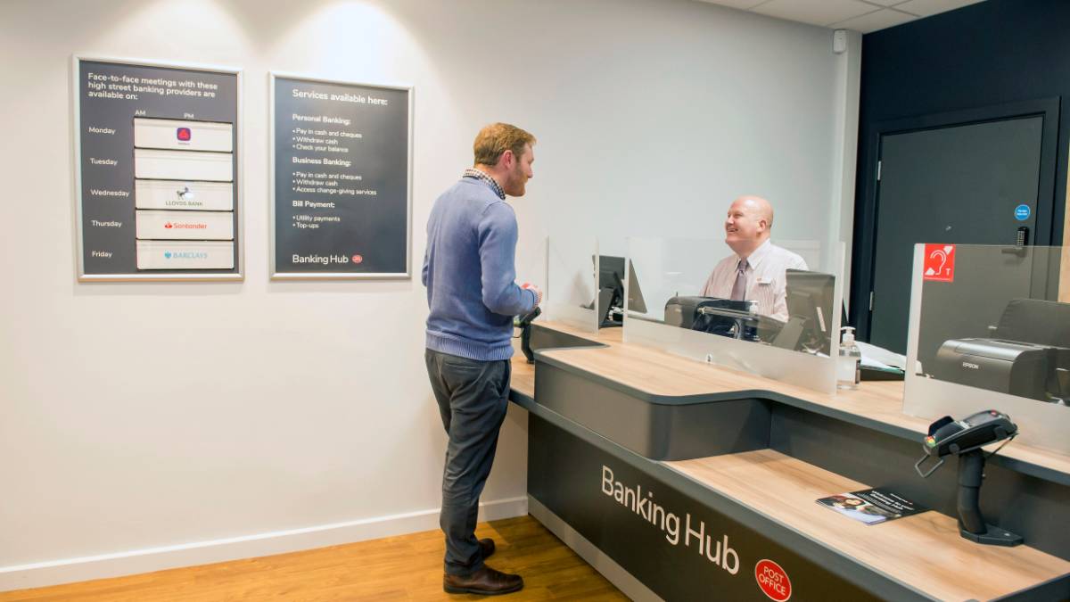 A customer being served at a Banking Hub counter