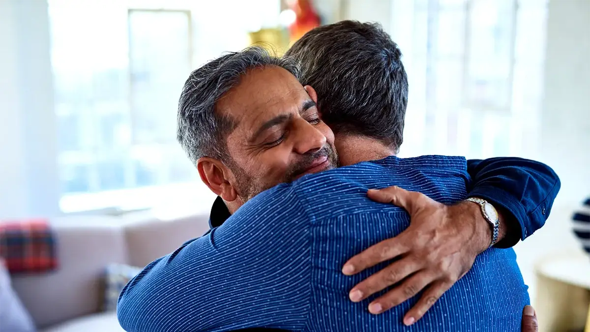 Two people hugging each other