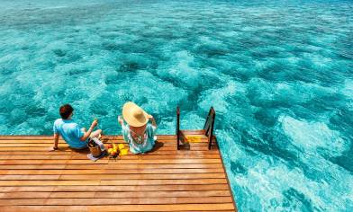 a couple relaxing by the sea with a picnic