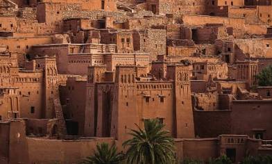 Ait Ben Haddou, a brown dessert stone hillside city in Morocco