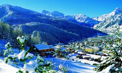 a mountain village nestled in a snowy valley