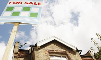 For sale Board in front of a house