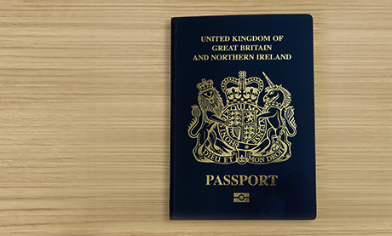 United Kingdom of Great Britain and Northern Ireland biometric passport on wooden surface